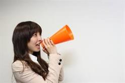 Woman speaking into orange megaphone