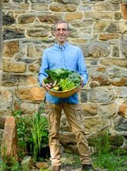 dr. ron weiss holding vegetables in a bowl