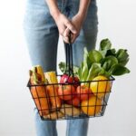 Top Cancer-Fighting Foods to Integrate into Your Diet - Person holding basket of cancer fighting vegetables