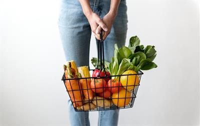 Top Cancer-Fighting Foods to Integrate into Your Diet - Person holding basket of cancer fighting vegetables