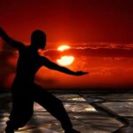 Meditation concept: male silhoutte against sunset Beat Cancer Blog